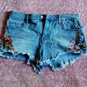 Womens size 12 high rise jeans shorts with flowers.